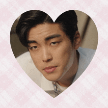a close up of a man 's face inside of a heart shaped frame