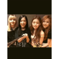 a group of young women are posing for a picture and one of them is holding a camera