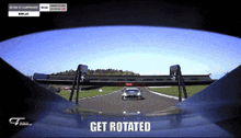 a car is driving down a race track and the word get rotated is on the bottom