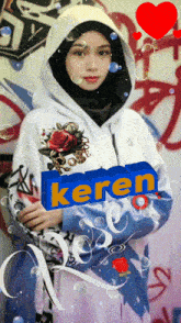 a girl wearing a hoodie with the word keren on the front
