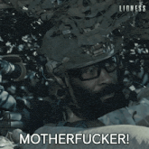 a man in a military uniform is holding a rifle and the words motherfucker are above him