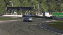 a car is driving on a track with a yellow sign that says ' sven '