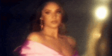a blurry picture of a woman in a pink dress .
