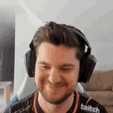 a man wearing headphones and a shirt with the word twitch on it