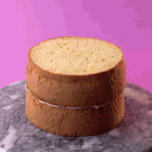 a cake sitting on a marble surface with the words mr.cakes written on the bottom