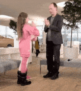 a man and a little girl are clapping their hands together