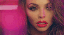 a woman with red lips and a nose ring