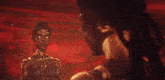 a man and a woman are standing next to each other in a dark room .