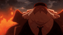 a man in a suit and tie stands in front of a burning fire