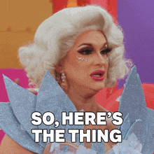a drag queen says " so here 's the thing " in front of her