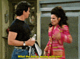 a man and a woman are standing next to each other and the woman is asking what the hell is wrong with you