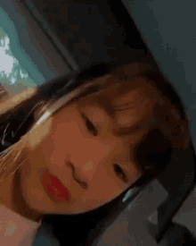 a close up of a woman 's face with headphones on