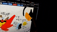 a computer screen shows a drawing of a cat and a red arrow pointing to the cat