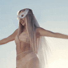 a woman wearing a veil and a mask with the letter p on her face
