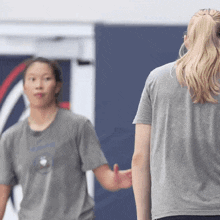 a woman wearing a grey shirt with the word nike on it