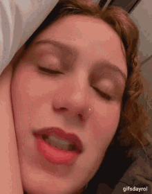 a close up of a woman 's face with the words gifsdayrol below her