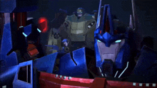 a group of transformers are looking at each other and one of them has a red light on his head