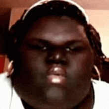 a close up of a person 's face with headphones on and a headband on .