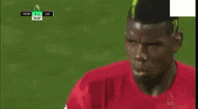 a soccer player is being tackled by another player on the field during a game .
