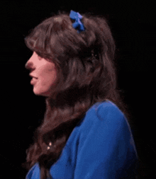 a woman wearing a blue headband with a blue bow on it