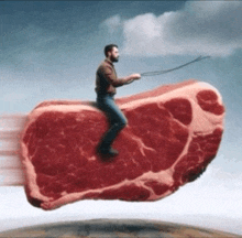 a man is riding on a large piece of meat