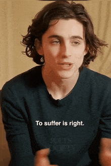 a young man wearing a shirt that says poet 's society on it