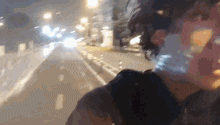 a blurry picture of a person walking down a street with a sign on the side that says ' a '