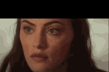 a close up of a woman 's face with her eyes closed