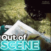 a person is drawing on a piece of paper with out of scene written on it
