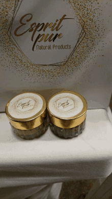 two jars of esprit pur natural products sit on a counter top