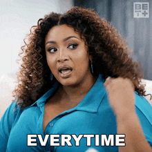 a woman with curly hair is making a funny face and says everytime
