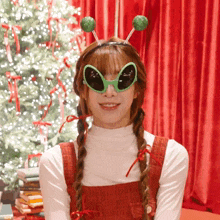 a girl wearing alien glasses and a headband