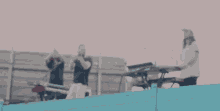 a group of men are playing keyboards and singing