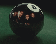 a pool ball with the number 8 on it is on a pool table