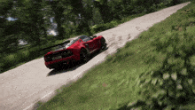 a red sports car is driving down a road with a license plate that says ' nc ' on it