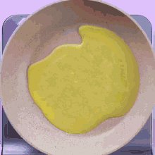 a yellow liquid is being cooked in a pot