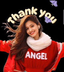 a woman wearing a red angel shirt is smiling