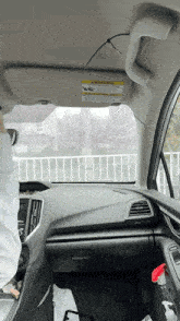 a car with a warning sticker on the sun visor