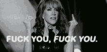 a black and white photo of a woman giving the middle finger