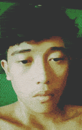 a close up of a man 's face with a green background