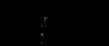 a white sphere is exploding in the dark on a black background