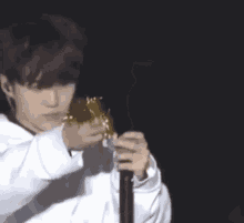 a person is holding a microphone in their hand and eating something