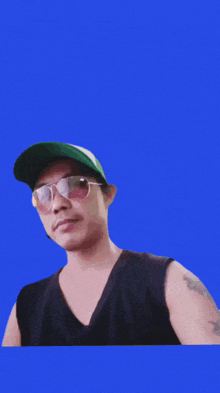a man wearing sunglasses and a green hat with the word bomber in red