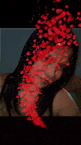 a woman is surrounded by red hearts and a purple light