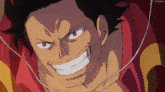 a man with a beard is smiling and wearing headphones and a red shirt