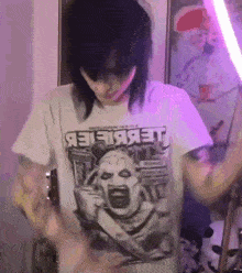 a person wearing a white t-shirt with a picture of a screaming clown and the word jet on it