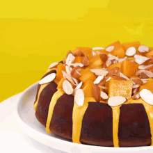 a chocolate cake with nuts on top of it on a white plate