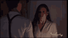 a man and a woman are looking at each other in a hallmark channel ad