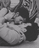 a man and woman are kissing in front of a sign that says garden resort