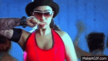 a woman wearing sunglasses and a top hat is being touched by a man 's hand .